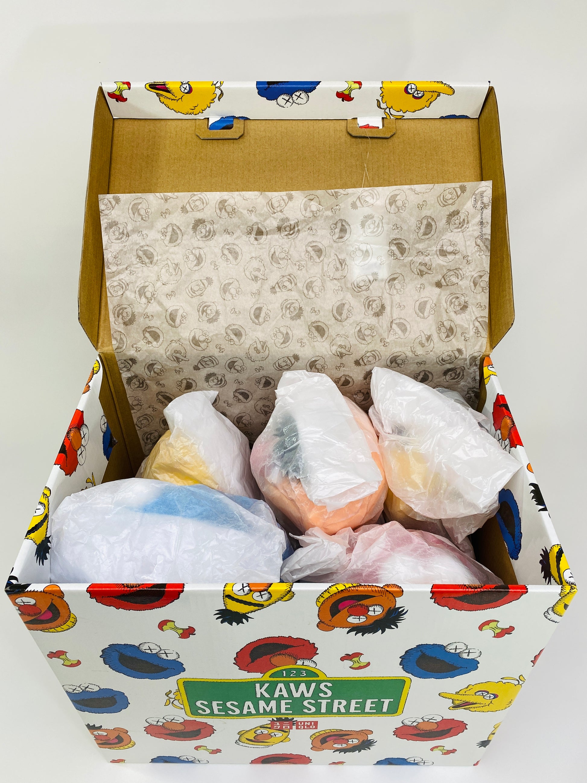 KAWS Uniqlo Sesame Street Plush Toy Box Open Showing Sealed Plush Toys